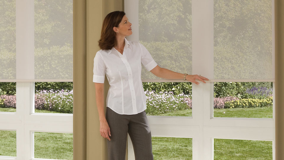 Woman standing in front of Cordless Roller Shades