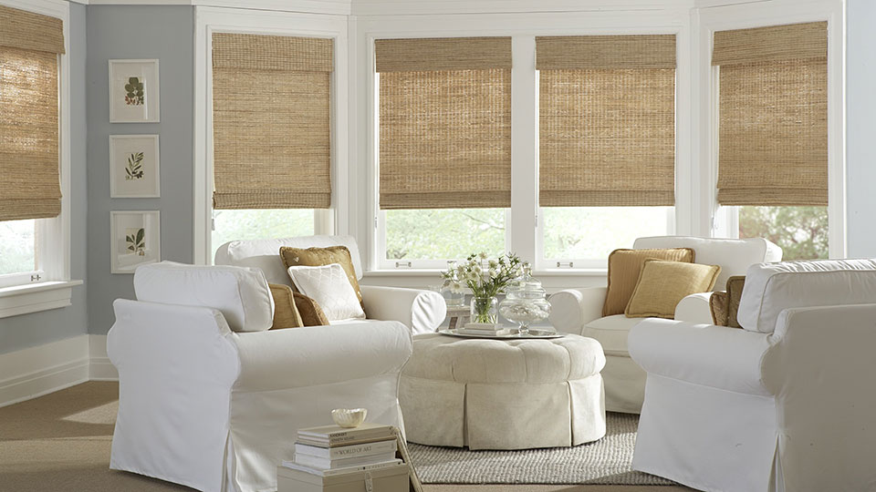Living room white easy chairs looking out through windows with Roman Natural Shades